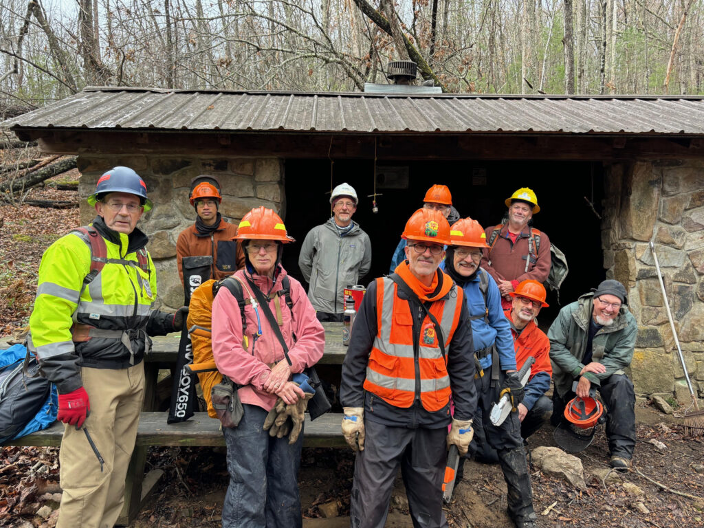 The group of 10 men who cleared downed trees posing in front of Trimpi shelter.